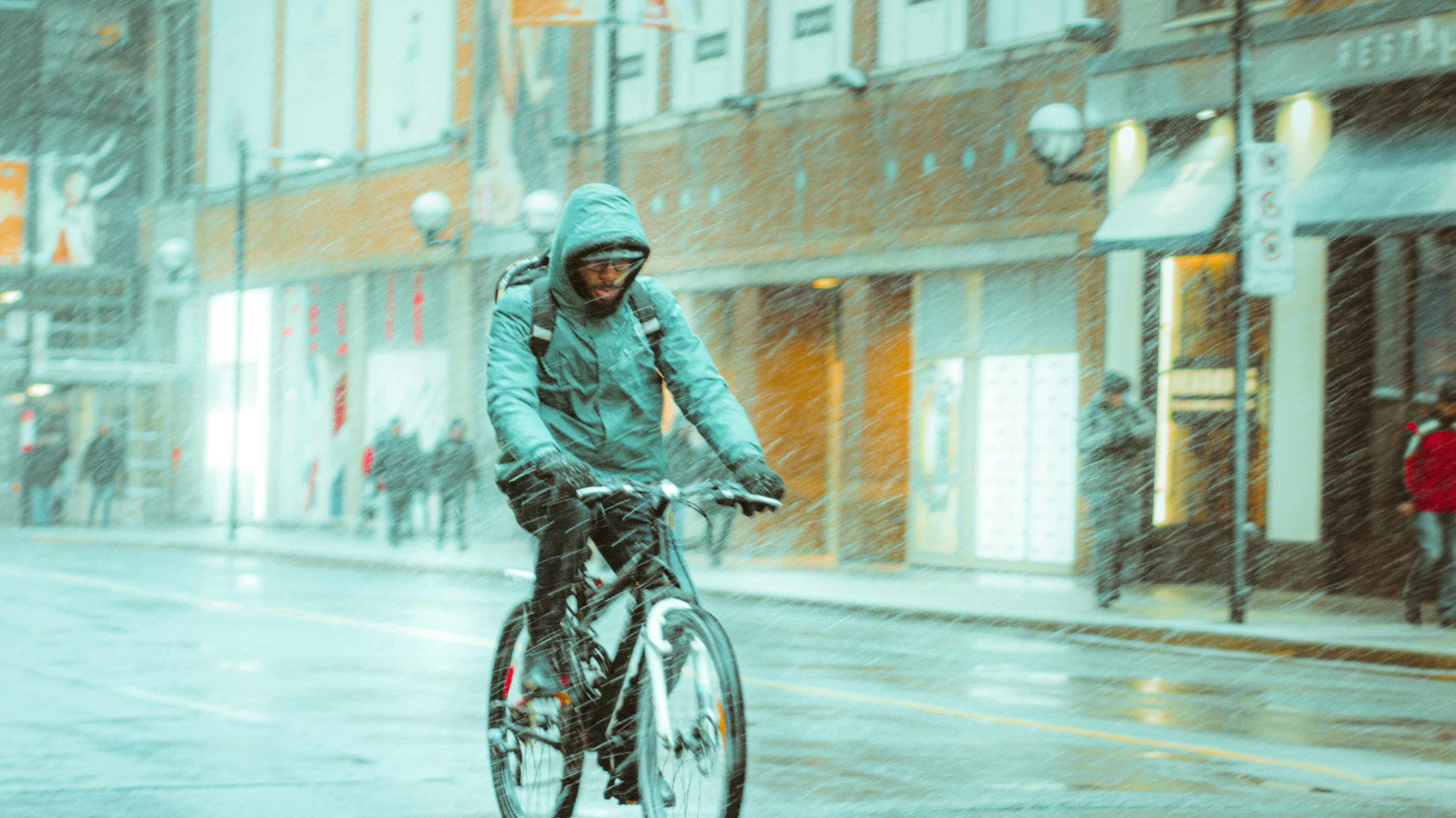 a man riding a bike in the rain