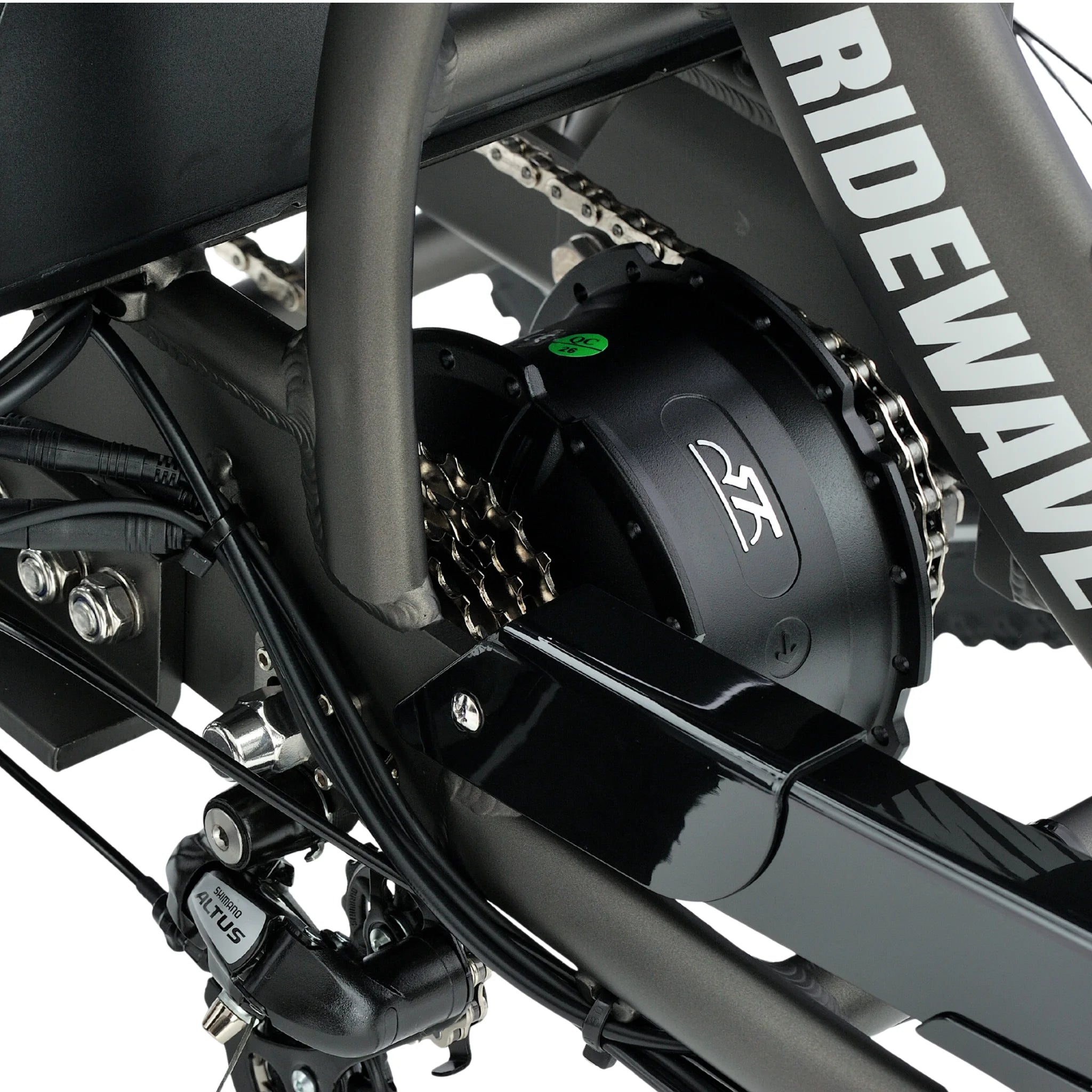 all-groups Close-up of a motorcycle chain and sprocket system with 'Ridewave' branding.
