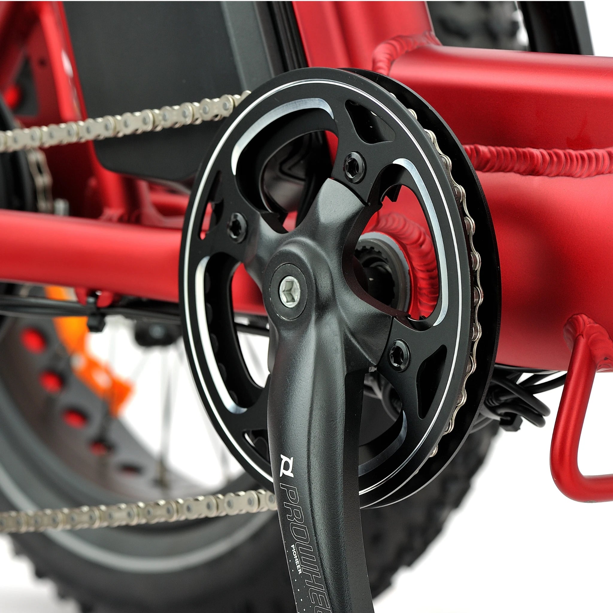 Close-up of a bicycle chain and sprocket system with a red frame.