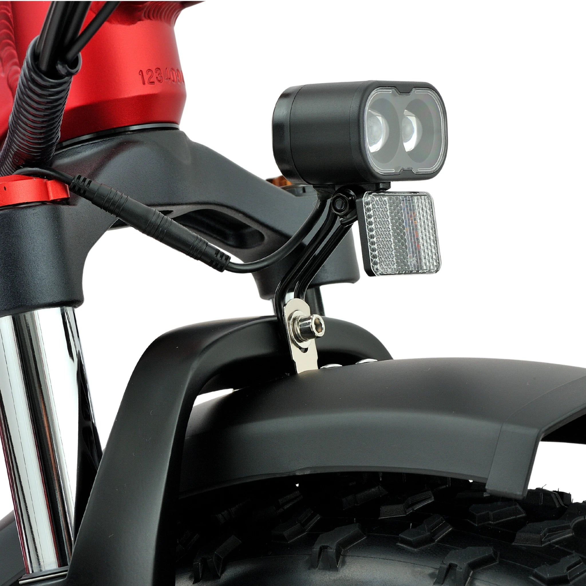 Close-up of a motorcycle headlight and front fender on a white background