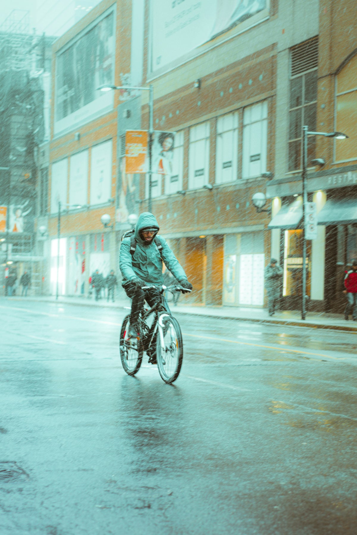 a man riding a bike in the rain