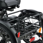 An electric tricycle with a black luggage rack on a white background