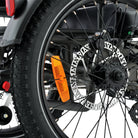 all-groups Close-up of a motorcycle wheel with an orange fender and visible brand name.