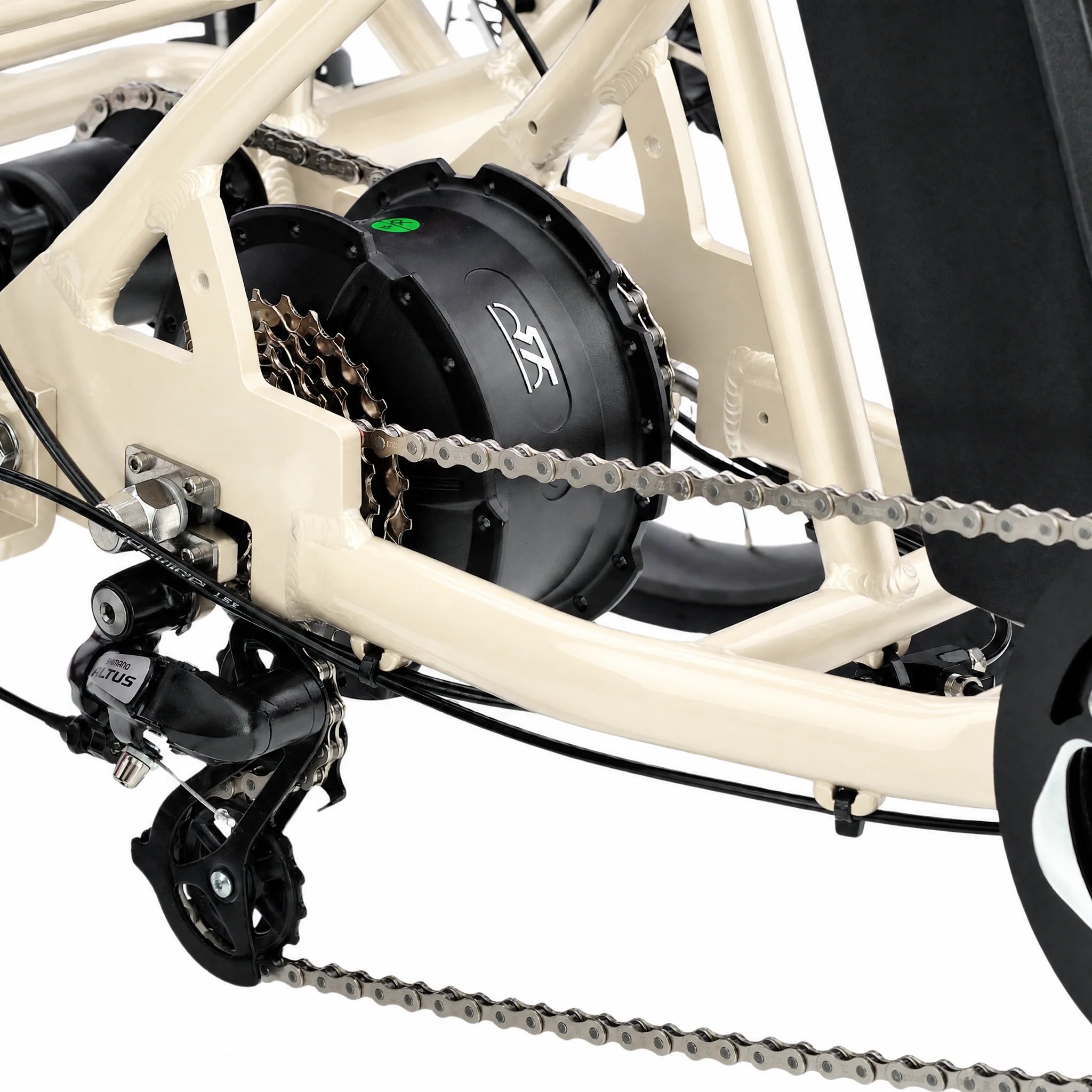 Close-up of a bicycle's gear system with a white frame and black components. #color_cream